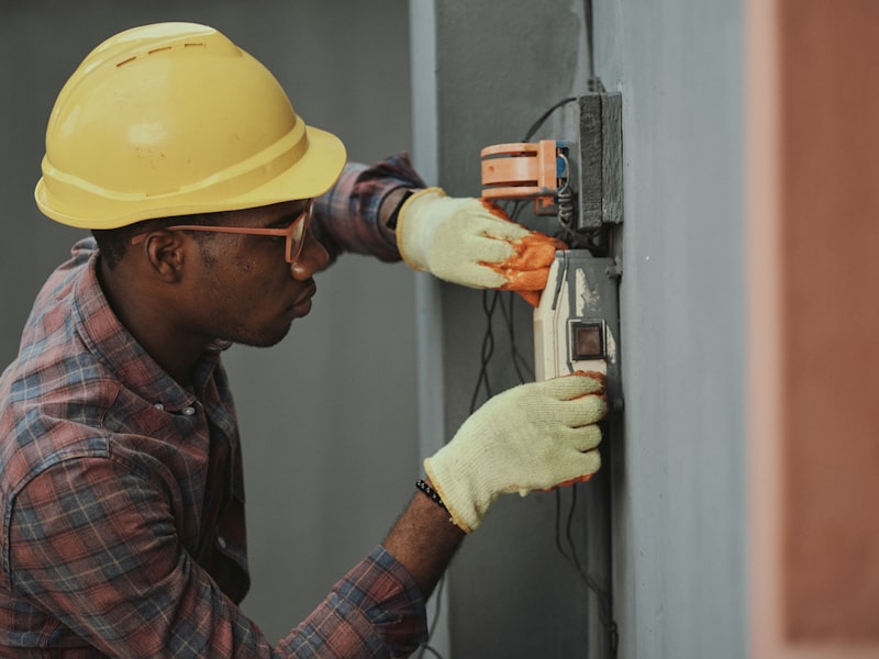 Worker in a hard hat and safety gloves during a maintenance task